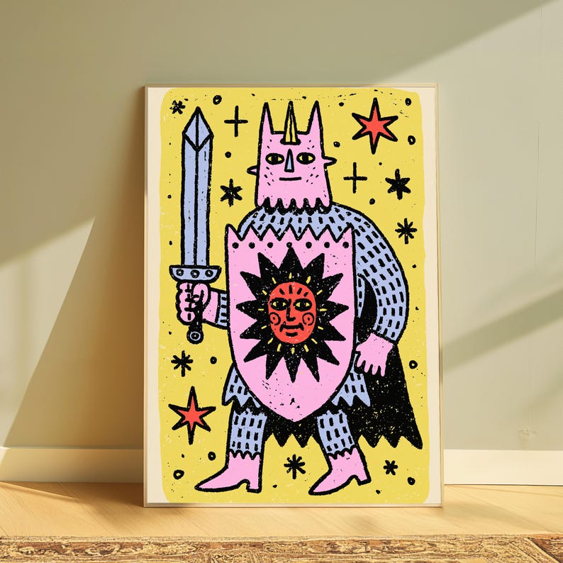May include: A rectangular art print featuring a pink horned figure in blue chainmail armour holding a light blue sword and a pink shield with a black sun graphic. The background is yellow with black stars and red star accents in a block print style.