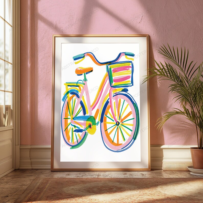 May include: A framed art print featuring a colorful, abstract illustration of a bicycle. The bicycle is rendered in vibrant brushstrokes of pink, orange, yellow, blue, and green, complete with a front basket and a seat, set against a white background.