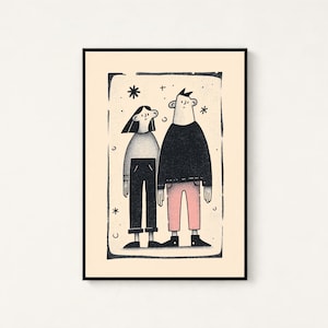 May include: A framed art print featuring a stylised illustration of two figures standing side by side. The figure on the left wears a grey top and black trousers, while the figure on the right wears a black top and pink trousers, set against a cream background.