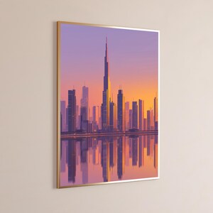 May include: A framed wall art print featuring a stylized cityscape of Dubai at sunset. The tall central skyscraper is surrounded by various buildings in shades of purple, orange, and yellow, with a clear reflection visible in the water below.