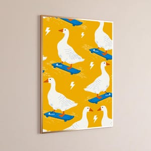 May include: A framed wall art print featuring a repeating pattern of white geese with orange beaks and feet, each wearing blue sneakers and riding a blue skateboard on a vibrant yellow background accented with white lightning bolt symbols.
