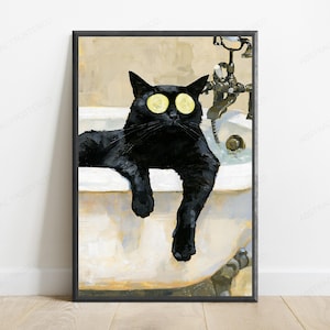 May include: A framed wall art print featuring a black cat relaxing in a white clawfoot bathtub. The cat has two yellow cucumber slices placed over its eyes. A vintage-style metal faucet is visible in the background of the tub, set against a neutral-toned wall.
