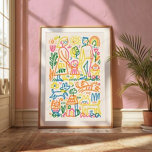 May include: A framed wall art print featuring a colorful, hand-drawn style illustration of a family, a house, a dog, and a cat. The artwork uses vibrant lines in red, orange, yellow, green, and blue to depict figures, a sun, and a rainbow.