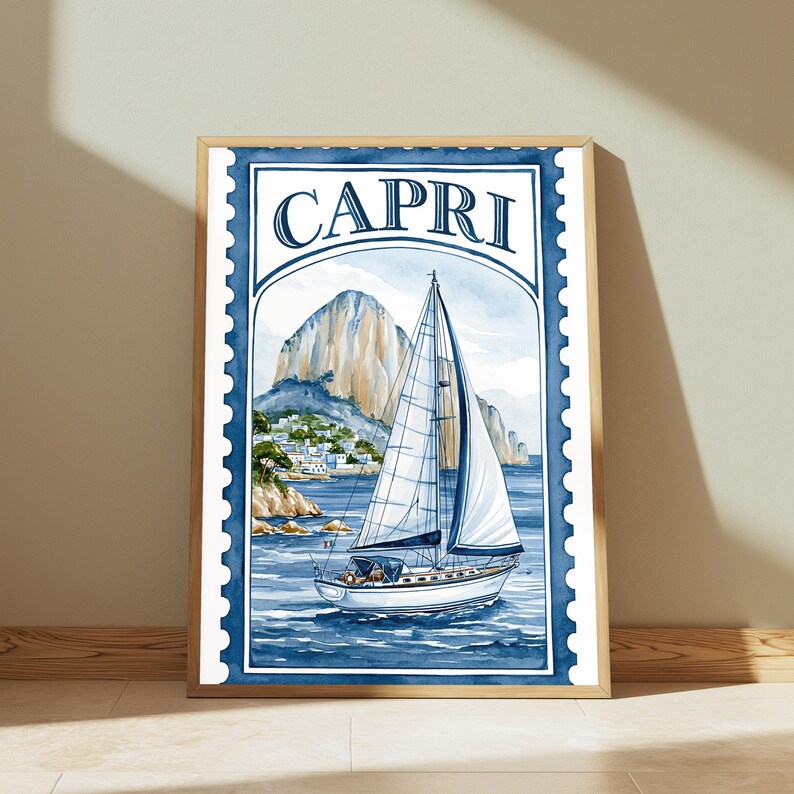 May include: A framed wall art print featuring a watercolor illustration of a sailboat on blue water with a rocky mountain and coastal buildings in the background. The design is styled like a postage stamp with the word CAPRI printed at the top.