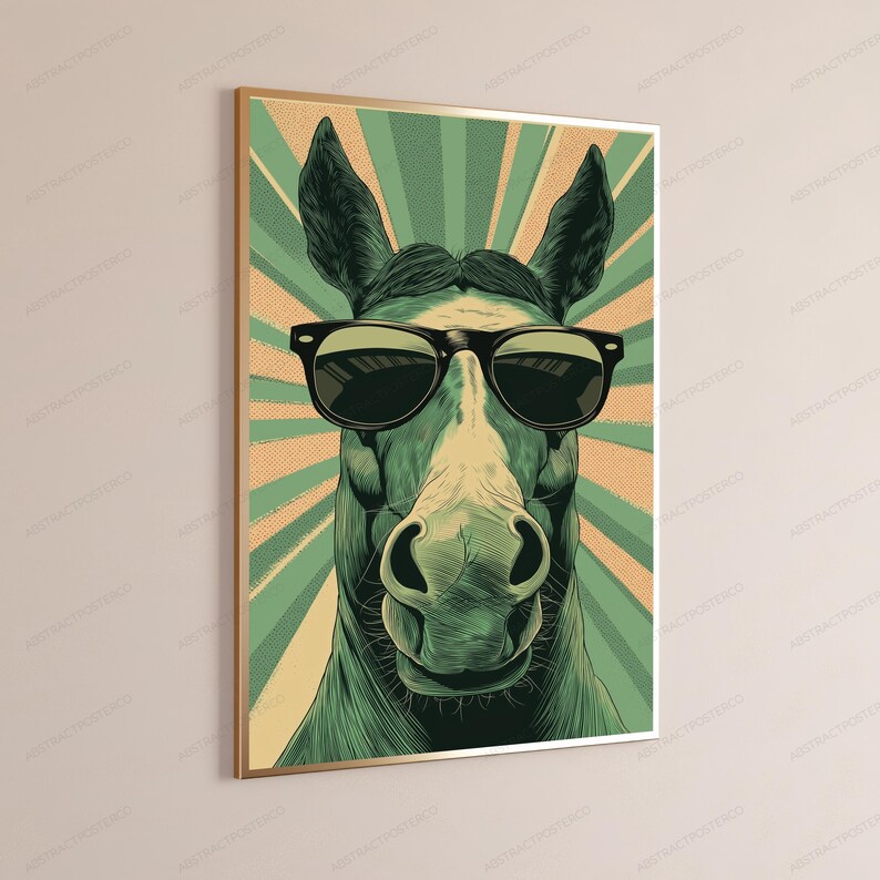 May include: A framed wall art print featuring a stylized illustration of a horse wearing black sunglasses. The horse is rendered in shades of green and cream, set against a background of radiating sunburst lines in alternating green and tan colors.