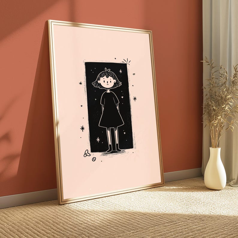 May include: A framed wall art print featuring a pale pink background with a central black rectangular panel. Inside the panel is a line-art illustration of a figure with short hair wearing a simple dress, surrounded by small star and circle motifs.