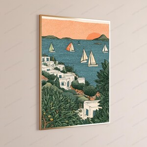 May include: A framed wall art print depicting a coastal scene with white buildings nestled among green trees and bushes. The blue sea features several sailboats under a soft orange sunset sky. The illustration uses a textured, graphic style.