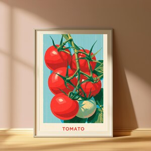 May include: A framed vertical art print featuring a cluster of bright red tomatoes on a green vine against a light blue background with thin vertical white stripes. The word TOMATO is printed in red capital letters at the bottom of the print.