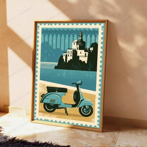 May include: A rectangular wall art print designed like a postage stamp featuring a light blue motor scooter in the foreground. The background displays a stylized illustration of a white building on a cliff overlooking a body of water in shades of blue.