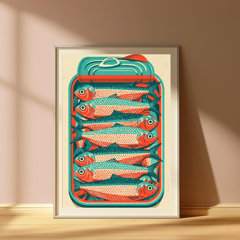 May include: A framed art print featuring a stylized illustration of a rectangular tin can filled with six stacked fish. The fish are rendered in shades of orange and teal, with a teal lid at the top. The background of the print is a light cream color.