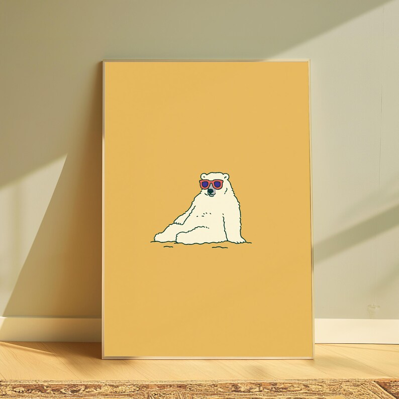 May include: A rectangular wall art print featuring a centered illustration of a white polar bear sitting down. The bear is wearing red-rimmed sunglasses with dark lenses. The background of the print is a solid, flat mustard yellow color.
