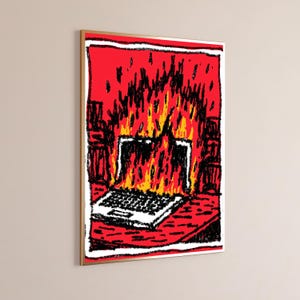 May include: A framed wall art print featuring a stylized, hand-drawn illustration of a laptop engulfed in bright yellow and orange flames against a vibrant red background. The artwork uses bold black outlines and a textured, crayon-like aesthetic.