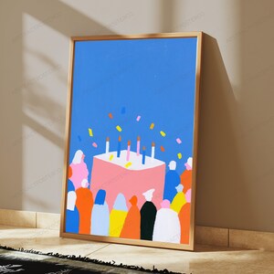 May include: A framed vertical art print featuring a large pink birthday cake with five lit candles on a solid blue background. The cake is surrounded by a crowd of stylized, colorful figures in various solid-colored clothing, with small confetti pieces.