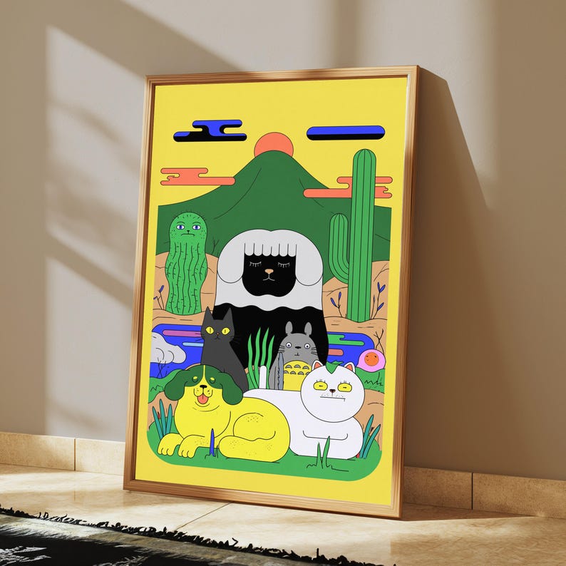 May include: A framed art print featuring a yellow background with a green mountain, a red sun, and cacti. The foreground displays a black sheep, a black cat, a grey creature, a yellow dog with green ears, and a white cat with green hair accents.