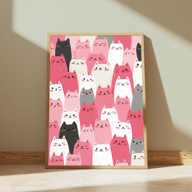 May include: A rectangular wall art print in a light wood frame featuring a dense, repeating pattern of stylized cats in shades of pink, white, black, and gray. The cats have simple facial features, with some winking and others smiling.