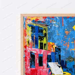 May include: A framed abstract painting featuring thick, textured brushstrokes in vibrant shades of blue, pink, yellow, and orange. The composition displays architectural shapes and bold color blocks with a visible impasto technique in a light wood frame.