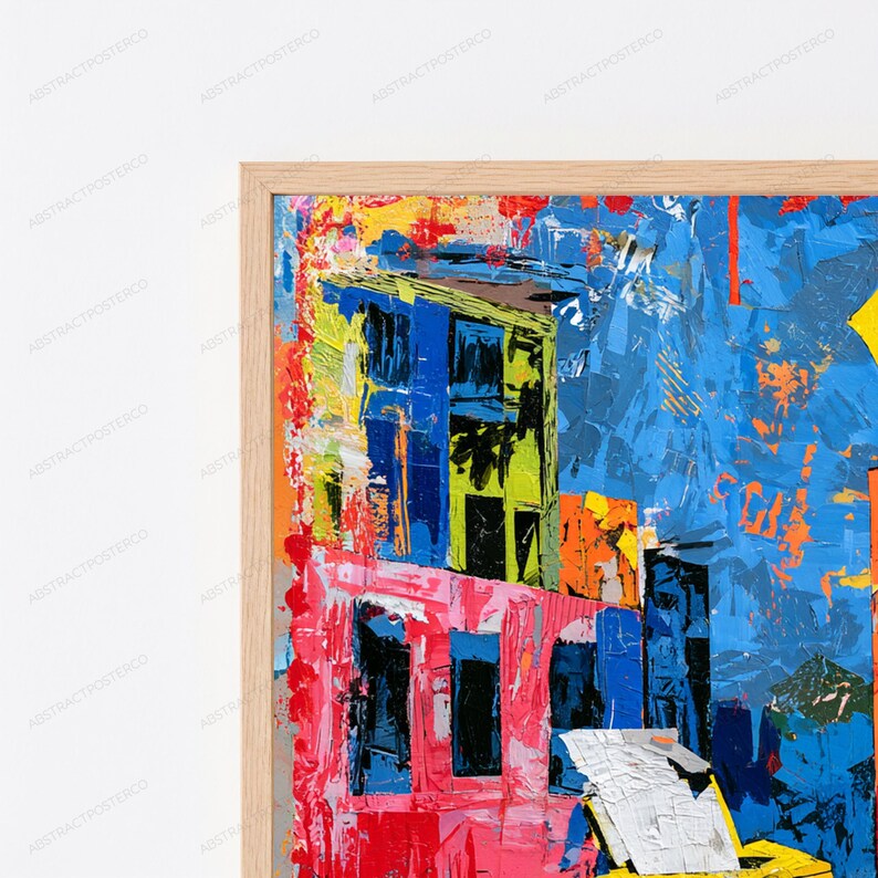 May include: A framed abstract painting featuring thick, textured brushstrokes in vibrant shades of blue, pink, yellow, and orange. The composition displays architectural shapes and bold color blocks with a visible impasto technique in a light wood frame.