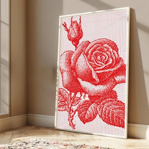 Pode incluir: Uma impress&atilde;o de arte de parede retangular emoldurada apresentando uma rosa vermelha e um bot&atilde;o de rosa sobre um fundo branco. O design usa um padr&atilde;o de pontos para criar a imagem da flor, folhas e caule em vermelho vibrante sobre fundo branco.