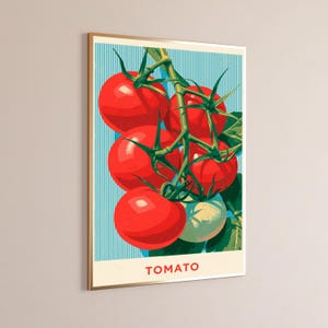 May include: A framed vertical wall art print featuring a cluster of bright red tomatoes on a green vine against a light blue background with vertical white stripes. The word TOMATO is printed in red capital letters at the bottom of the artwork.