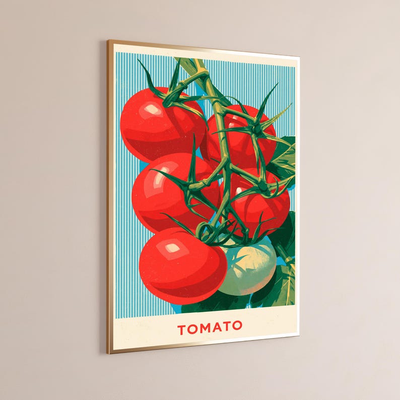 May include: A framed vertical wall art print featuring a cluster of bright red tomatoes on a green vine against a light blue background with vertical white stripes. The word TOMATO is printed in red capital letters at the bottom of the artwork.