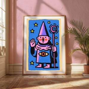 May include: A framed art print featuring a stylized illustration of a pink-skinned figure wearing a pointed hat and a blue robe with a central eye motif. The figure holds a staff topped with a crescent moon, surrounded by yellow stars on a blue background.
