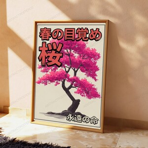 以下が含まれることがあります： 鮮やかなピンクの葉と暗い幹を持つ、様式化された桜の木が描かれた額入りアートプリント。クリーム色の背景に、黒と赤で「春の目覚め」「桜」「永遠の命」という日本語のテキストが記されており、シンプルな木製のフレームに収められています。