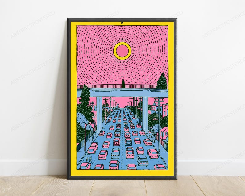 May include: A framed art print featuring a stylized illustration of a highway filled with pink cars under a bridge. A lone figure stands on the bridge beneath a large yellow sun against a pink sky. The scene includes green trees and utility poles.