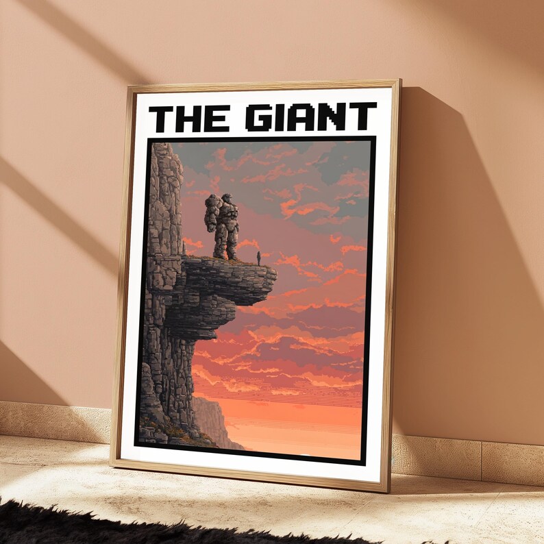 May include: A framed rectangular wall art print titled THE GIANT in black pixelated font. The artwork depicts a large stone-like figure standing on a cliff edge overlooking a vast landscape under a vibrant orange and pink sunset sky.