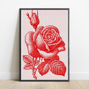 Pode incluir: Uma impress&atilde;o de arte de parede retangular emoldurada apresentando uma ilustra&ccedil;&atilde;o em pontos vermelhos de uma rosa em flor e um bot&atilde;o de rosa sobre um fundo branco coberto com uma grade densa de pequenos pontos vermelhos. A obra est&aacute; numa moldura preta fina.