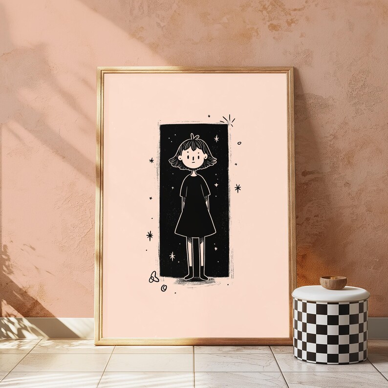 May include: A framed wall art print featuring a black and white line drawing of a person with short hair wearing a dress, centred within a solid black rectangular background surrounded by small star and circular shapes on a light peach background.
