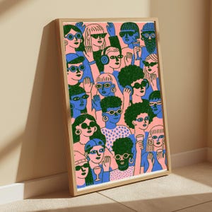 May include: A framed rectangular art print featuring a dense crowd of people illustrated in a flat graphic style. The figures are rendered in shades of pink, blue, and dark green, with many wearing sunglasses, hats, and holding drinking glasses.