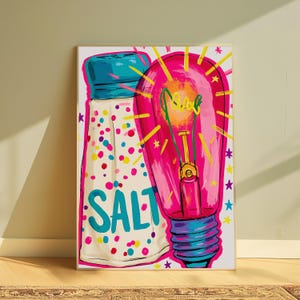 May include: A rectangular art print featuring a stylized illustration of a salt shaker with a blue cap and colorful confetti dots, alongside a large, glowing pink light bulb with a yellow filament, all set against a white background.