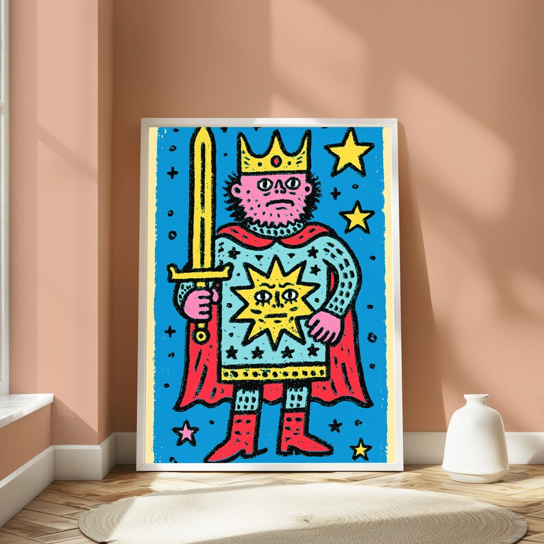 May include: A framed art print featuring a stylized illustration of a king with a beard, wearing a crown and a red cape, holding a yellow sword. The figure is set against a bright blue background decorated with yellow stars and a central sun icon.