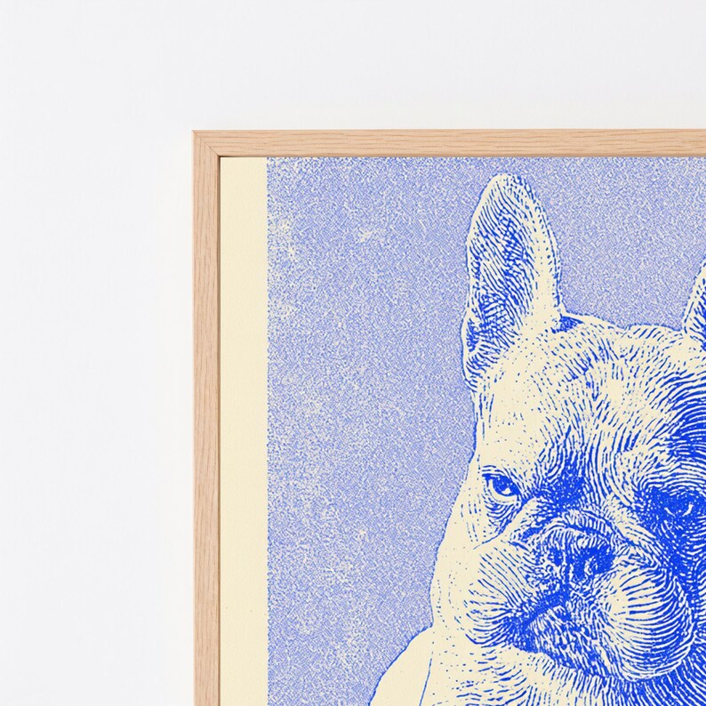 May include: A framed wall art print featuring a blue and cream-colored illustration of a French Bulldog. The dog is depicted with detailed line work, showing its characteristic upright ears and wrinkled face, set within a light-colored wooden frame.
