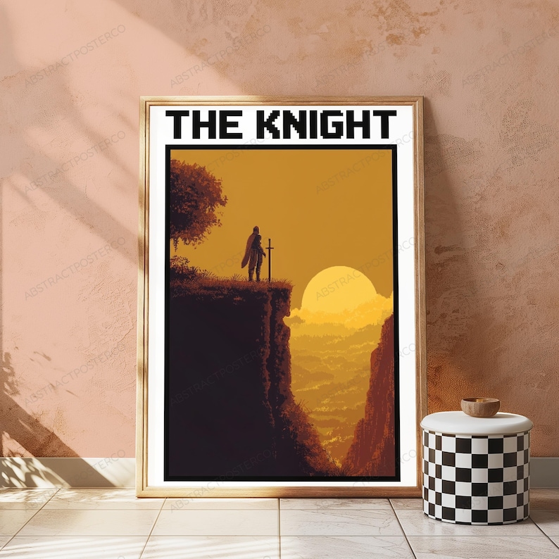 May include: A framed vertical poster titled THE KNIGHT in pixelated black font. The artwork depicts a silhouette of a knight holding a sword standing on a cliff edge overlooking a valley at sunset with a large yellow sun against an orange sky.
