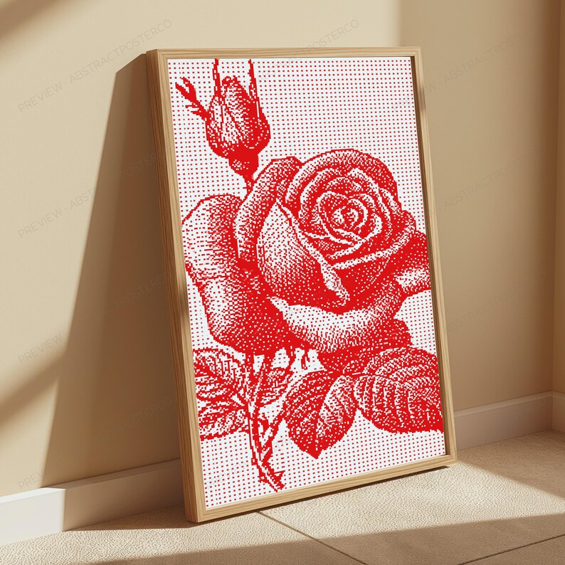 Pode incluir: Uma pe&ccedil;a de arte de parede retangular emoldurada com uma ilustra&ccedil;&atilde;o pontilhada em vermelho de uma rosa em flor e um bot&atilde;o de rosa sobre um fundo branco. A obra utiliza um estilo de matriz de pontos para criar sombreamento e textura, em uma moldura de madeira clara.