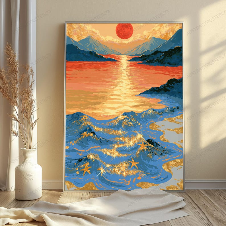 May include: A rectangular wall art print featuring a landscape of blue mountains and a calm orange sea under a large red sun. The foreground shows blue ocean waves with gold glitter accents and small starfish shapes scattered across the water surface.