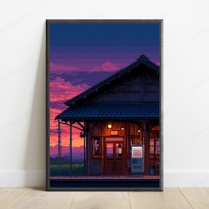 May include: A framed pixel art print depicting a wooden train station building at sunset. The sky features vibrant shades of purple, pink, and orange clouds. The station has a dark tiled roof, warm interior lighting, and a vending machine.