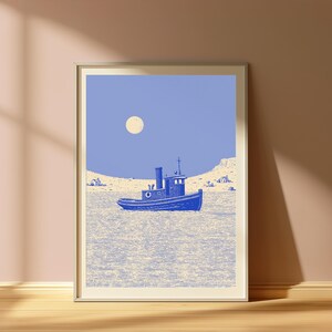 May include: A framed art print featuring a blue tugboat centered on a textured, light-colored sea. The background shows a pale, cream-colored shoreline with small buildings under a solid periwinkle blue sky with a round, pale moon.