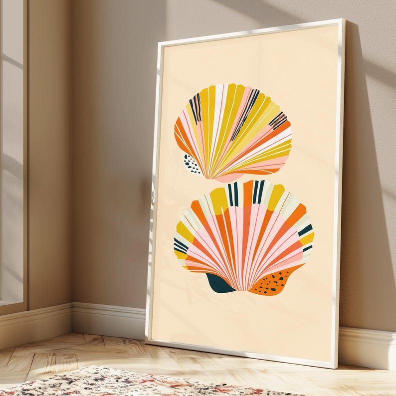 May include: A framed vertical wall art print featuring two stylised seashell illustrations on a light cream background. The shells are rendered in vibrant shades of yellow, orange, pink, and dark teal, with linear patterns and small black dots.