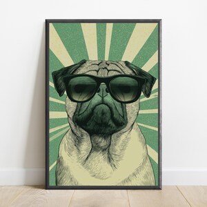 May include: A framed wall art print featuring a detailed illustration of a pug dog wearing black sunglasses. The pug is centered against a background of alternating light cream and muted green sunburst rays, creating a graphic, high-contrast visual.
