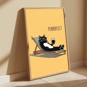 May include: A framed wall art print featuring a black and white cat wearing yellow sunglasses, relaxing on a light blue lounge chair while holding a dark beverage. The background is solid yellow with the text PURRRFECT printed in black.