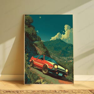 May include: A vertical art print featuring a red sports car driving on a winding mountain road. The scene includes lush green hills, a distant town, and a clear blue sky with white clouds. The car has pop-up headlights and multi-spoke wheels.