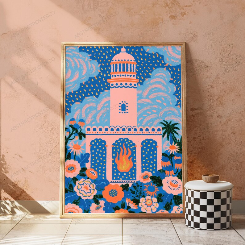 May include: A framed art print featuring a pink lighthouse structure centered against a dark blue sky with stylized clouds and rain. The foreground displays a vibrant garden of orange and pink flowers, green foliage, and a central flame graphic.