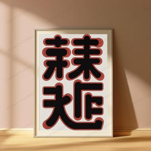 May include: A framed wall art print featuring four large, bold black Chinese characters arranged in a two-by-two grid. Each character is outlined with a textured, reddish-orange border that creates a subtle shadow effect against the off-white background.
