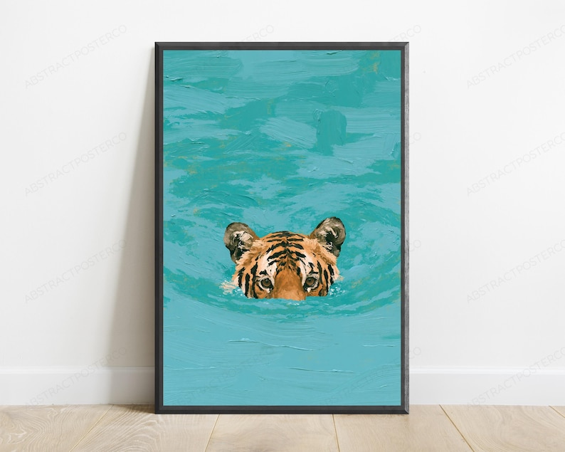 May include: A framed wall art print featuring an oil painting style depiction of a tiger's head emerging from vibrant turquoise water. The tiger has orange fur with black stripes and is positioned in the centre of the textured blue water surface.