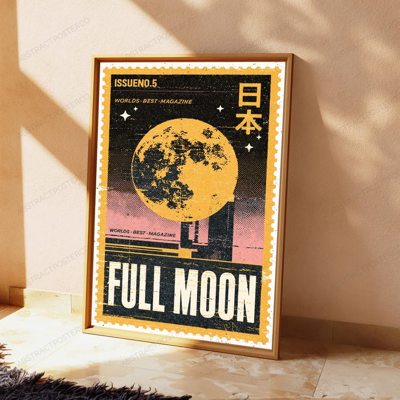 May include: A rectangular poster in a wooden frame featuring a vintage postage stamp design. The artwork displays a large yellow full moon against a black starry sky, with the text ISSUE NO. 5, WORLDS BEST MAGAZINE, and FULL MOON in white.