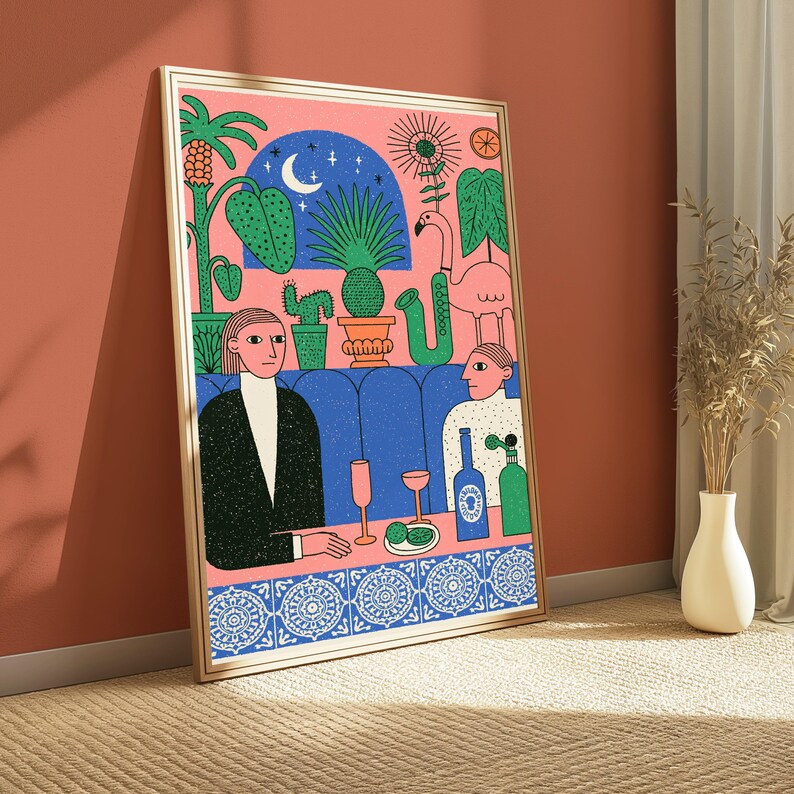 May include: A framed art print featuring a stylized illustration of two figures sitting at a table in a booth. The scene includes a pink background, a blue arched window with a crescent moon, potted plants, a flamingo, a saxophone, and drinks.