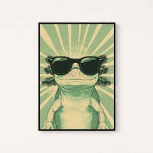 Puede incluir: Una impresi&oacute;n de arte mural enmarcada que presenta un ajolote verde claro con gafas de sol negras. El ajolote est&aacute; centrado sobre un fondo de rayos de sol radiantes en verde claro y crema, creando un estilo de ilustraci&oacute;n gr&aacute;fica.