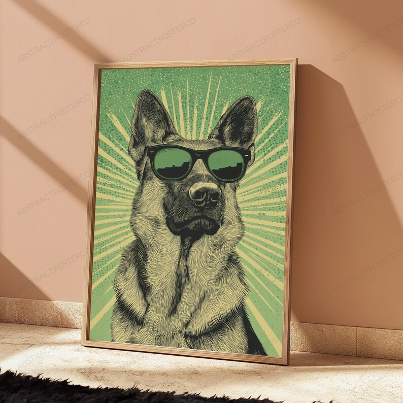 May include: A framed wall art print featuring a detailed illustration of a German Shepherd dog wearing black sunglasses. The dog is centered against a green background with a radiating sunburst pattern and a subtle dotted texture throughout.